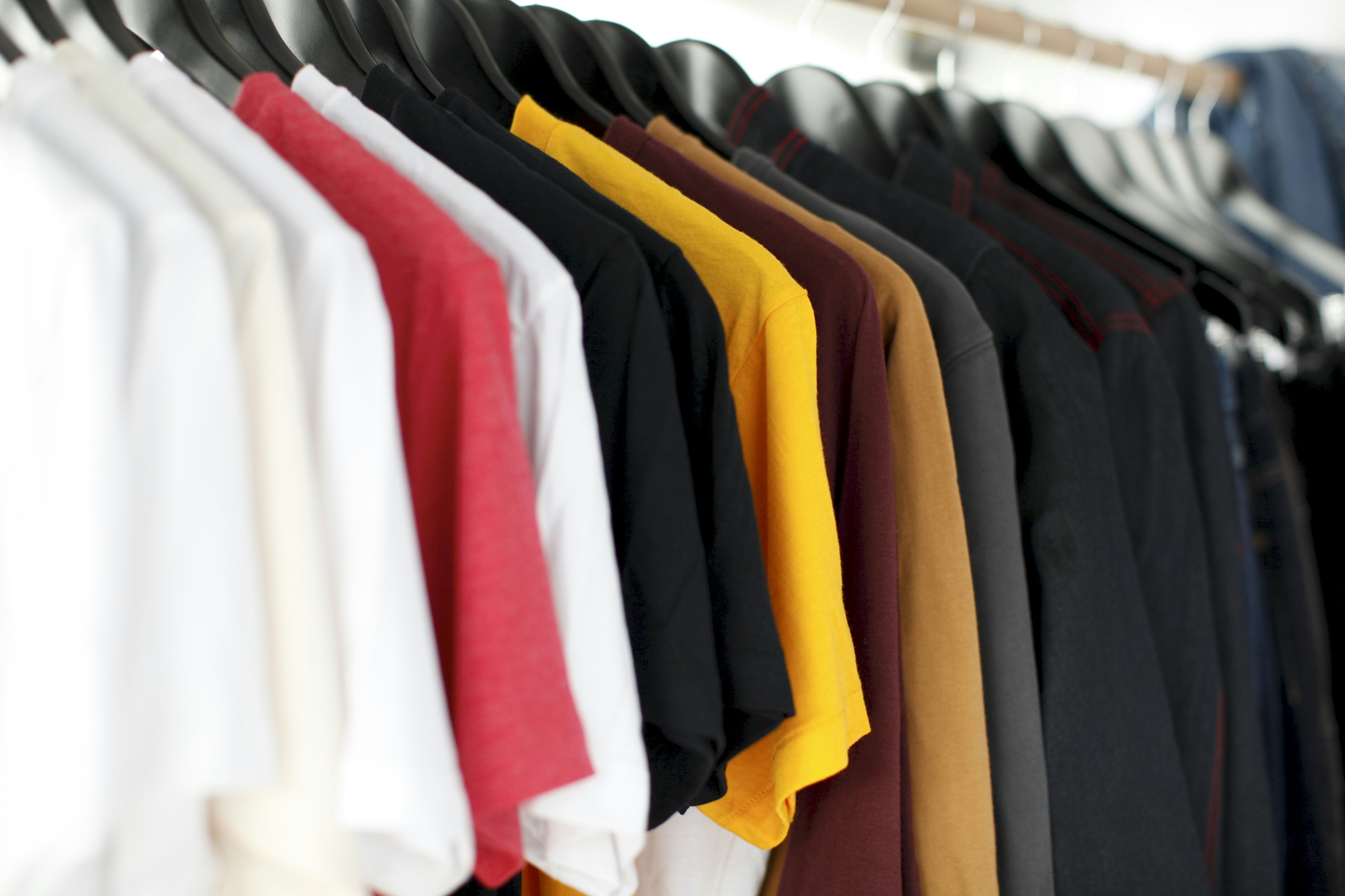 Rows of secondhand clothing in a donation center