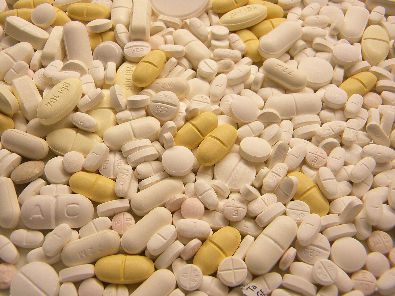 A close view of assorted white and yellow unused tablets collected for medical-waste treatment.